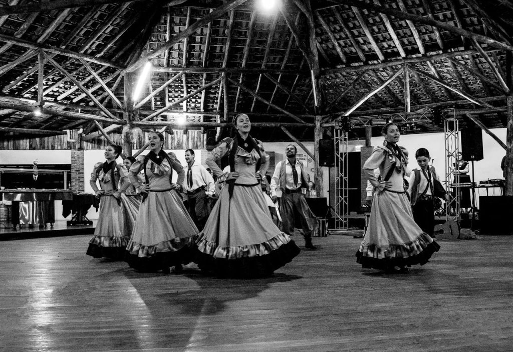 Mastering the First Impression: Your intriguing post title goes here Black and white image of a cultural dance performance in a rustic indoor setting.