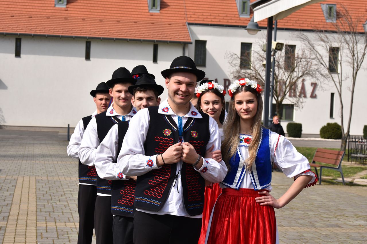 A group of young adults in traditional Hungarian folk costumes in Máriapócs, Hungary.